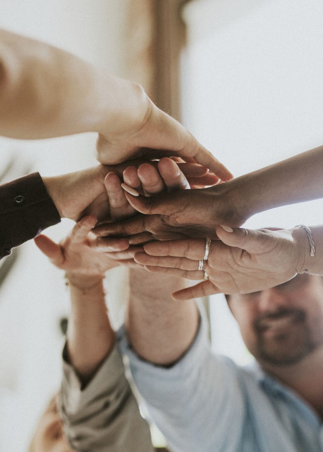 Team members stacking hands together