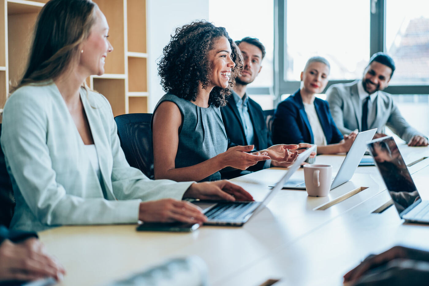 A leadership team in discussion around a meeting table